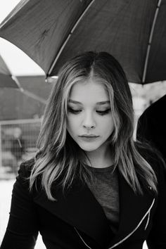 black and white photograph of a woman holding an umbrella