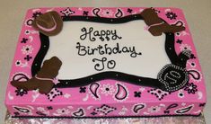 a pink and black birthday cake with cowboy hats on it