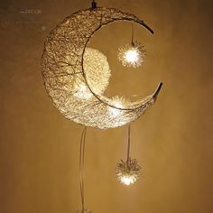 the moon and stars are hanging from the ceiling in front of the light brown wall