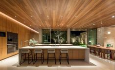 a large kitchen with an island counter and bar stools