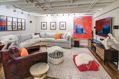 a living room filled with furniture and pictures on the wall next to a fire place