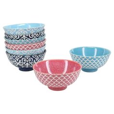 four bowls are stacked on top of each other in different colors and designs, one is blue