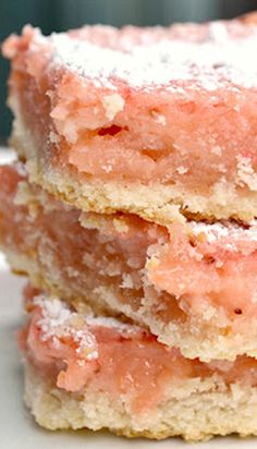 three pieces of cake sitting on top of a white table