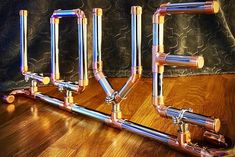 the pipes are connected to each other on the wooden floor in front of a curtain