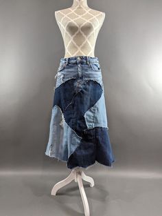 "Long upcycled denim patchwork skirt with frayed seams and jagged hem. American Eagle brand waist is size 10 but I feel it measures more of a medium. Waist measures 31\", hips 36\" and length is approximately 31\". This skirt has a bit of stretch to it." Medium Wash Cotton Skirt With Patchwork, Dark Wash Patchwork Cotton Skirt, Dark Wash Cotton Patchwork Skirt, Cotton Skirt With Patchwork In Medium Wash, Cotton Patchwork Skirt In Dark Wash, Dark Wash Patchwork Denim Skirt, Dark Wash Denim Skirt With Patchwork, Denim Blue Patchwork Skirt From Recycled Denim, Patchwork Denim Skirt In Recycled Denim Blue