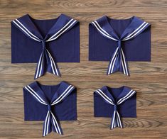 four pieces of blue cloth with white stripes tied around the neck and two sets of matching napkins