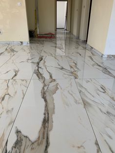 marble flooring in an empty room with white walls and floors that have been stripped off