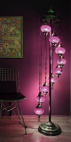 a lamp that is sitting in the middle of a room with pink lights on it