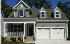 a house with two garages and three windows