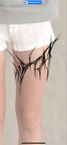 the back of a person's legs with black ink on them and white shorts