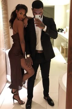 a man and woman taking a selfie in a bathroom