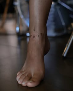 a close up of a person's foot with tattoos on it