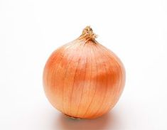 an onion sitting on top of a white surface