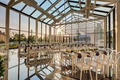 the inside of a building with tables and chairs set up for a formal dinner or function