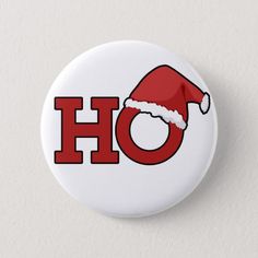 a button with the word ho on it and a santa's hat in red