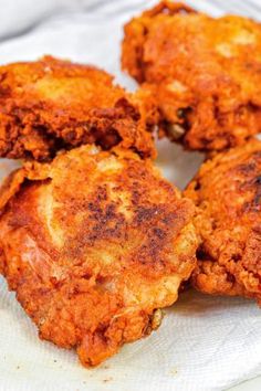 four fried chicken patties on a paper plate