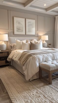 a large white bed sitting in a bedroom next to two lamps on either side of the bed