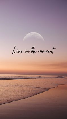 a beach with the words live in the moment on it and an ocean view at sunset