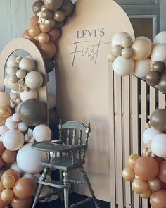 a chair sitting in front of a wall with balloons