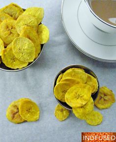 two bowls filled with banana chips next to a cup of coffee