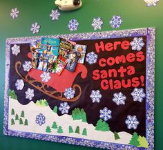 a bulletin board is decorated with snowflakes and christmas books for the santa clause