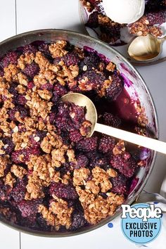 a bowl filled with blueberry crisp on top of a table