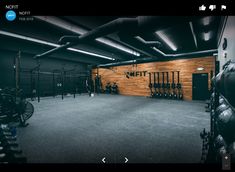 the inside of a gym with equipment on the wall and in the background is a bike rack