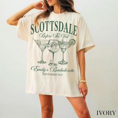 a woman wearing a t - shirt that says scottsdale before the grill and drinks beneath it