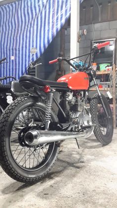 an orange and black motorcycle parked in a garage