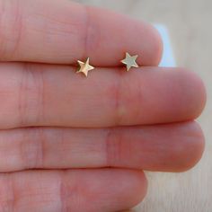 Tiny, plain minimalist star earrings! Perfect for a dainty look or on multiple piercings! ►► Details ▸ Measures 5mm x 5mm ▸ Made of 925 Sterling Silver plated in 14k Gold, 14k Rose Gold, or Rhodium ▸ We use a THICK plating for piece that will last you years to come ▸ Sold as a PAIR ▸ Push back closure ▸ Nickel-free ▸ Hypo-allergenic ✈️Ships outs SAME DAY for fast delivery. Domestic Orders are delivered at your doorstep in 2-3 days! 🎁Packaged in a white gift box, ready for gift-giving! If you ha Tiny Star Earrings For Everyday, Tiny Star Earrings For Everyday Wear, Minimalist Star Charm Earrings For Everyday, Minimalist Star Earrings For Everyday, Minimalist Star Charm Earrings As Gift, Minimalist Star Charm Earrings, Dainty Tiny Star Earrings, Hypoallergenic Star-shaped Everyday Earrings, Hypoallergenic Star Earrings For Everyday