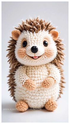 a crocheted hedge doll sitting on top of a white table next to a gray wall