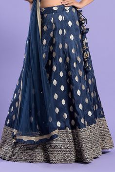 Navy blue kalidar lehenga with zari work border. Paired with V neck padded blouse sequin highlights and net embroidered border dupatta.
Components:3
Pattern:Embroidered
Type of Work:Zari and Sequin Work
Neckline:V Neck
Sleeve Type:Sleeveless
Fabric:Georgette, Dupatta: Net
Color:Blue
Other Details:
Deep V back
Back tie-up straps on blouse
Tassel details
Closure:
Lehenga: Side tie-up
Blouse: Back tie-up, hook and eye
Note: Latkans may vary as per availability in the market
Occasion:Sangeet,Destina V Neck Lehenga, Work Lehenga, Zari Work, Two Sisters, Set For Women, Aza Fashion, Lehenga, Types Of Sleeves, Sequin