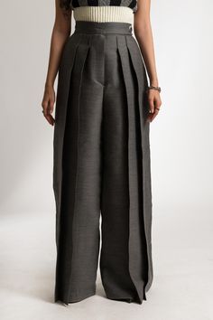 The Rosalie Pants are high-rise, wide leg trousers, crafted from a wool blend. The pants offer a flattering fit around the waist and hips. The look is finished with visible stitching detailing through the entire length of each pleat. ITEM DETAILS: - Two Front Pleats on Each Side - Side Button Closure - Hidden Front Zipper - Wide Leg Pant - Visible Pleat Hem Stitching  The model is 173cm high and wears size EU36/US4/UK8 MADE TO ORDER All our pieces are made to order only. We don't keep inventory, so every clothing piece we sell is made from scratch. As a clothing brand, we strongly believe that putting personalization before mass production is really important, as we want to build a sustainable brand that creates timeless clothing pieces you'll have in your wardrobe for years to come. When