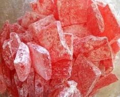 a bowl filled with sugar cubes sitting on top of a counter