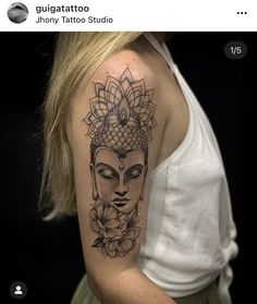 a woman's arm with a tattoo on it that has a buddha head and flowers