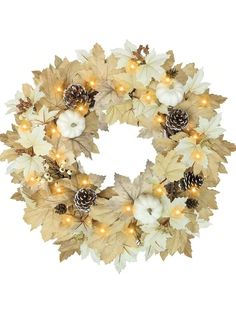 a wreath with white pumpkins and pine cones on the front, surrounded by lights