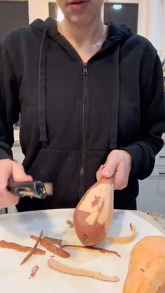 a person cutting up some food on a plate