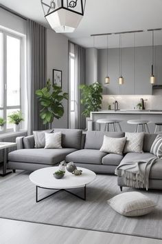 a living room filled with furniture next to a window and a table on top of a rug