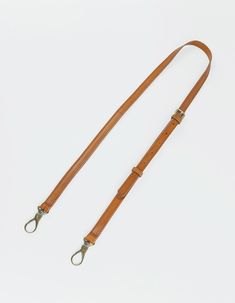 The details on this strap are made from our classic leather, which has a classy, yet modern and sophisticated look. It is characterized by its shining surface and a smooth and gentle feel. Our premium quality sustainable leather is tanned without the use of harmful chemicals and has no synthetic top finish. This natural leather has an open structure, which means that scratching will occur and irregularity in color and texture are a part of this leather. These characteristics make it a unique pro Formal Brown Bridle Leather Belts And Suspenders, Brown Leather Shoulder Strap, Luxury Leather Shoulder Strap For Everyday, Classic Adjustable Belts And Suspenders For Everyday, Brown Leather Shoulder Strap For Everyday Use, Everyday Brown Leather Shoulder Strap, Elegant Leather Belts And Suspenders With Leather Strap, Adjustable Leather Shoulder Strap For Daily Use, Brown Leather Strap Belts And Suspenders