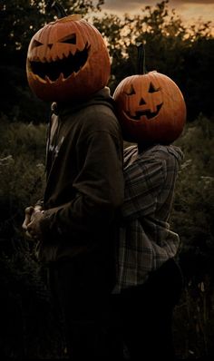 two people with pumpkins on their heads