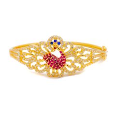 This royal decorative bangle bracelet, crafted from 22k gold and weighing 17.9 grams, features an exquisite peacock design, embellished with cubic zirconia stones that enhance its luxurious yellow gold finish. The bangle has a diameter of 2.25 inches and an oval shape opening, providing a comfortable fit. It is designed with a spring hinge and clasp for ease of opening and secure wear. Ideal for those who appreciate the majesty and beauty of peacock symbolism combined with the sparkle of cubic z Gold Bangle Bracelet With Peacock Design, Gold Peacock Design Bangle Bracelet, Elegant Gold Bangle With Peacock Design, Gold Bracelet With Peacock Design As Gift, Gold Bracelets With Peacock Design As Gift, Elegant Gold Bracelet With Peacock Design, Elegant Gold Bracelets With Peacock Design, Elegant Festive Bracelets With Peacock Design, Festive Elegant Bracelets With Peacock Design