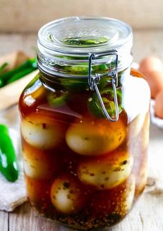 a jar filled with pickled vegetables on top of a wooden table