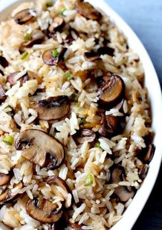 a bowl filled with rice and mushrooms on top of a table