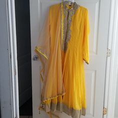 Beautiful Gorgeous Yellow Dress With Silver Design And Contrast Beige/Cream Color Dupatta. Great For Parties Or Weddings Ceremonies Yellow Traditional Drape Dress For Eid, Yellow Bollywood Dress With Traditional Drape, Traditional Drape Yellow Dress For Eid, Yellow Dress With Pallu For Eid, Yellow Dress With Sheer Dupatta For Diwali, Yellow Floor-length Dress With Sheer Dupatta, Yellow Fitted Dress With Sheer Dupatta, Fitted Yellow Dress With Sheer Dupatta, Yellow Anarkali Salwar Kameez With Sheer Dupatta