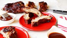 ribs on red plates with dipping sauce and chopsticks