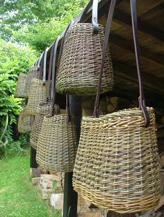 several wicker bags hanging from the side of a building