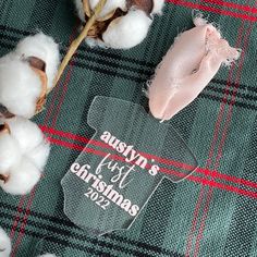 a glass ornament sitting on top of a pile of cotton next to a twig