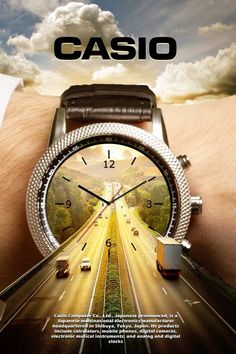 a wrist watch with an image of cars on the road and clouds in the background