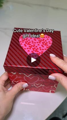 someone is holding a valentine's day gift box