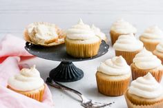 cupcakes with white frosting on a black plate